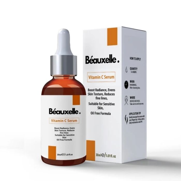 Béauxelle Vitamin C Serum in an amber glass dropper bottle next to its white and orange packaging box, on a clean white background.